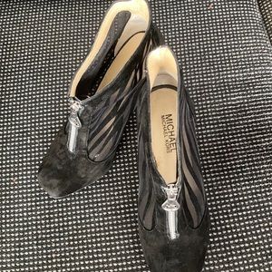 Black MK ankle boots.  Silver zipper with logo.